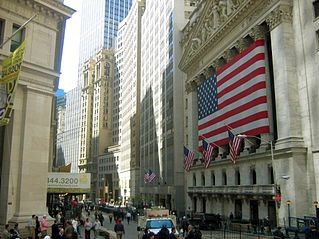 Wall Street:
      Wall Street is an eight-block-long street running roughly northwest to southeast from Broadway to South Street, at the East River, in the Financial District of Lower Manhattan in New York City. Over time, the term has become a metonym for the financial markets of the United States as a whole, the American financial services industry (even if financial firms are not physically located there), or New York-based financial interests. Anchored by Wall Street, New York City has been called both the most economically powerful city and the leading financial center of the world, and the city is home to the world's two largest stock exchanges by total market capitalization, the New York Stock Exchange and NASDAQ. Several other major exchanges have or had headquarters in the Wall Street area, including the New York Mercantile Exchange, the New York Board of Trade, and the former American Stock Exchange.